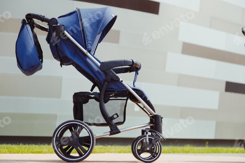 Preview: Modern contemporary blue baby stroller with bascket and handbag outdoors side view