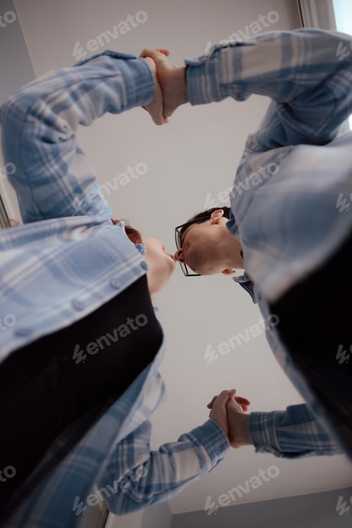Preview: lifestyle celebrating Valentine's Day at home. romantic couple in love holding hands