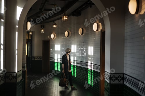 Preview: Stylish woman walking in tiled hall