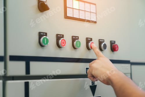 Preview: Electrical engineer man checking voltage and test at the Power Distribution Cabinet in control room