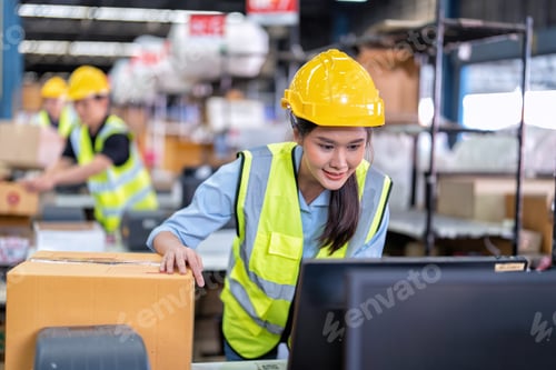 Preview: Worker working in the large depot storage warehouse happy smiling packing box at cashier counter