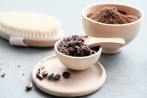 Preview: home made coffee body scrub in a bowl and ground coffee and body brush