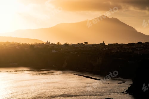 Preview: Houses of Procida in magic sunset with the island of Ischia in the background.
