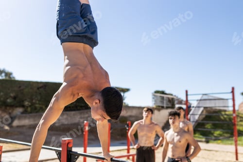 Preview: Man Doing Handstand on Bar with Friends