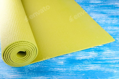 Preview: Yoga mat on wooden background. Equipment for yoga. Concept healthy lifestyle