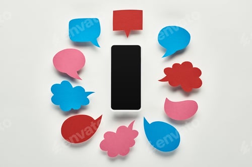 Preview: top view of smartphone with blank screen on white background near empty colorful speech bubbles,