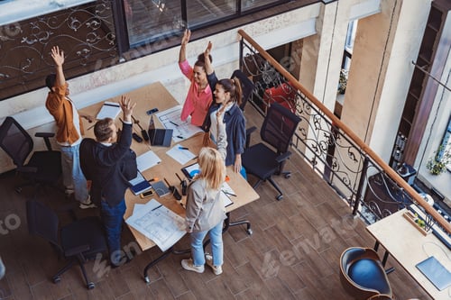 Preview: Smiling diverse business people vote with raising hands at corporate meeting. Team building
