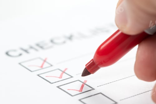 Preview: Hand with red marker pen marking on checklist box