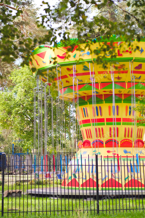 Preview: Bright beautiful chain carousel in the park. Joy and fun. Vacations and holidays.