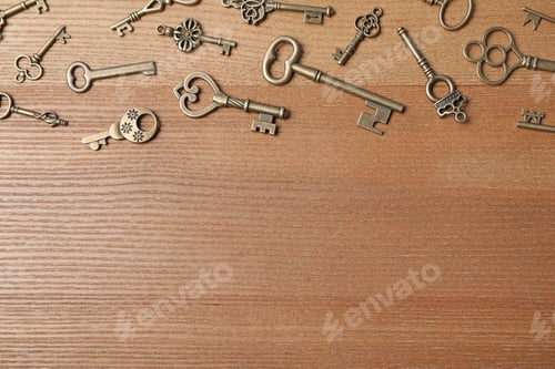 Preview: Old vintage keys on wooden background, flat lay. Space for text