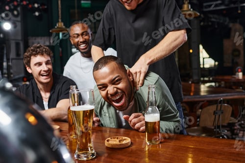 Preview: man touching shoulders of excited african american groom during bachelor party, male friendship