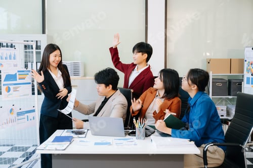 Preview: Group of diverse businesspeople using a laptop and tablet in office.