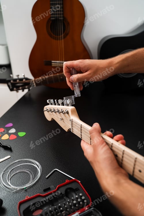 Preview: Guitar string tightening and maintenance on headstock using winder