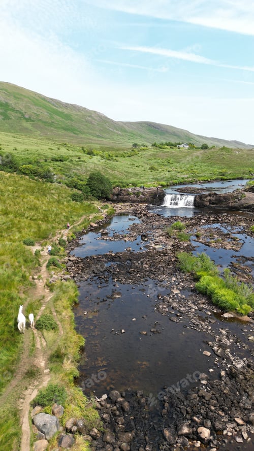 Preview: Vertical high-angle view of a creek in Connemara, Ireland with mountains in the background
