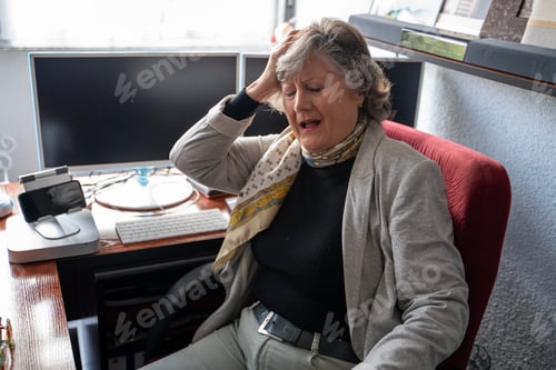 Preview: mature gray-haired woman with headache