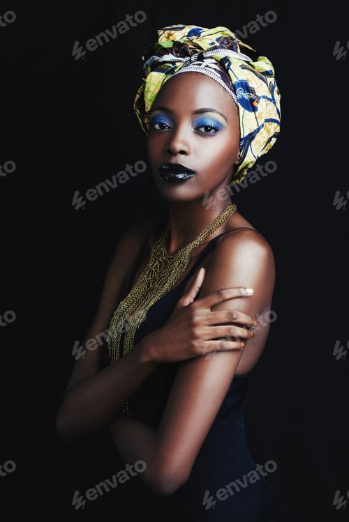 Preview: Shes a true african beauty. A beautiful african woman posing against a black background.
