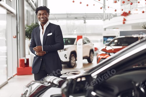 Preview: Handsome and elegant black man in a car salon