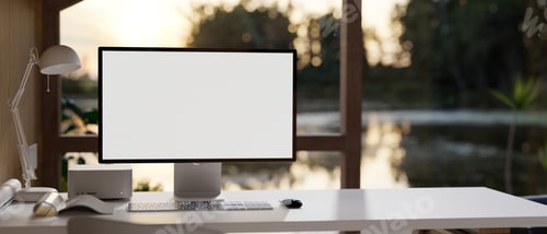 Preview: Modern home workplace with PC computer on table over blurred beautiful lake in background.