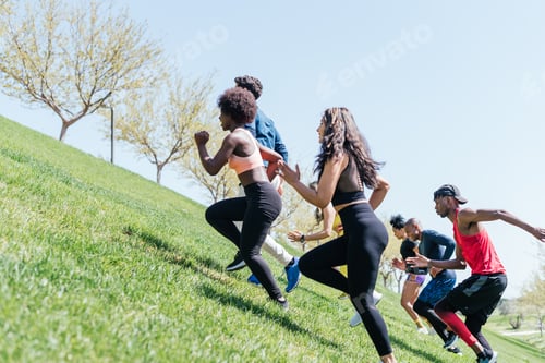 Preview: Group of runners running up a hill. Horizontal framing.