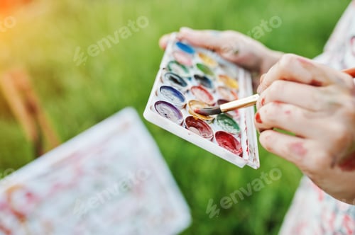 Preview: Hands Mixing Watercolors in Green Field