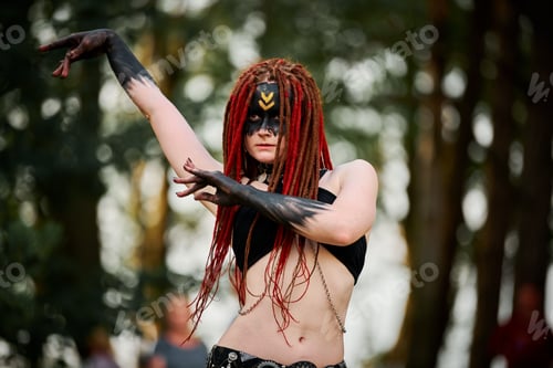 Preview: Mythological dancing girl faun on green lawn in public park outdoor art dancing event