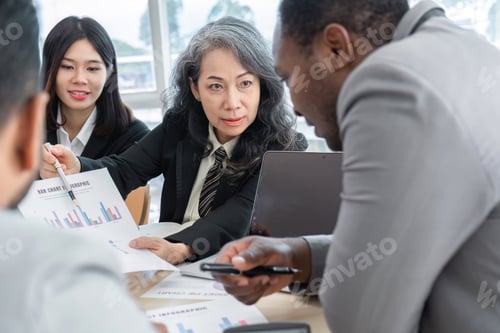 Preview: Business People Meeting using laptop computer,calculator,notebook,stock market chart paper for
