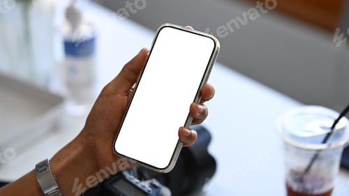 Preview: Close up view young woman hand holding smart phone with white empty screen.