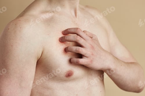 Preview: Man scratching bare chest with copy space