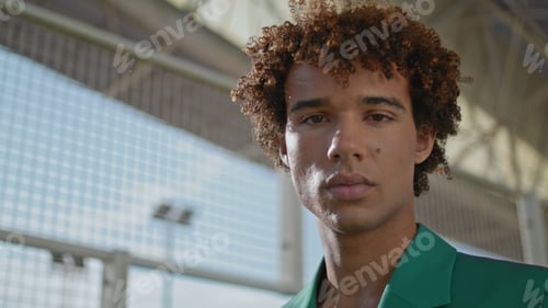 Preview: Serious teenager modelling street portrait. Elegant man face posing camera