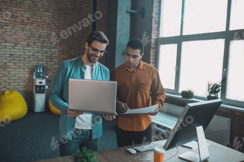 Preview: Joyful positive colleagues working together in the office