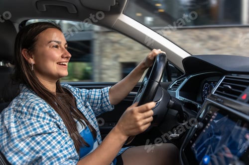 Preview: Happy woman driving car in city. Modern trip with a smile