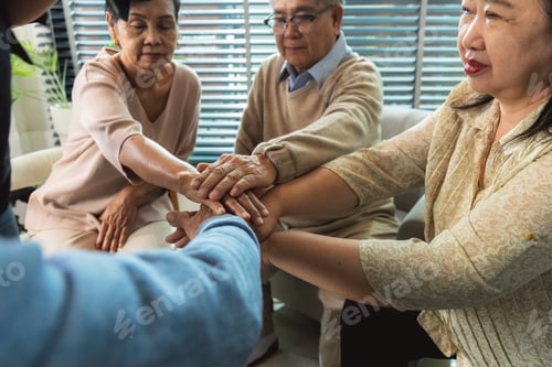 Preview: Group of Asian elderly people joining hands together