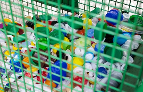 Preview: Urban Recycling bin full of plastic bottle caps