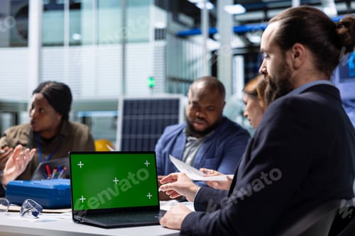 Preview: Factory investor uses green screen laptop, examining financial statements