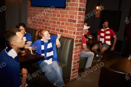 Preview: Group of Diverse Young Football Fans Watching Match in Sports Bar