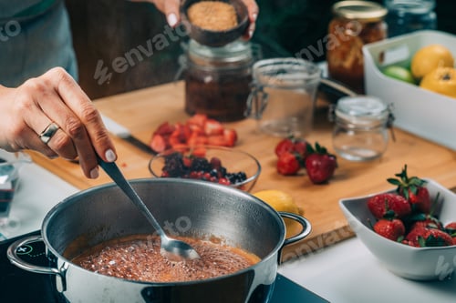 Preview: Woman Cooking Fruits and Making Homemade Jam.