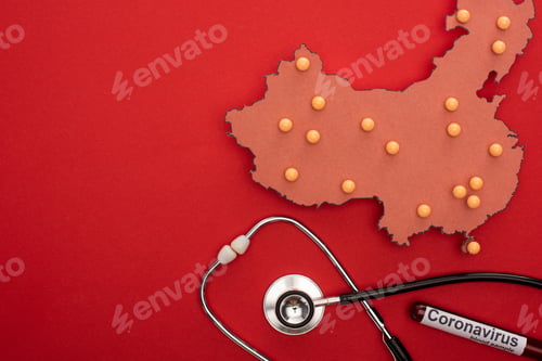 Preview: Top view of push pins on map of china with stethoscope and test tube with coronavirus lettering on