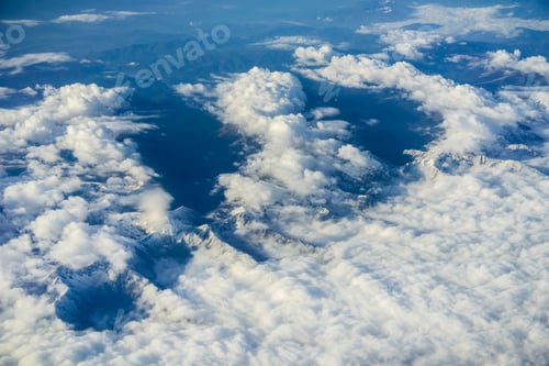 Preview: Aerial view of white clouds covering the snow capped Carpathian mountains, Europe; airplane view