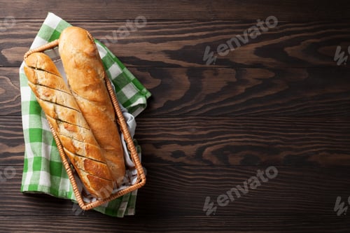 Fresh Baguettes in a Woven Basket on Wood