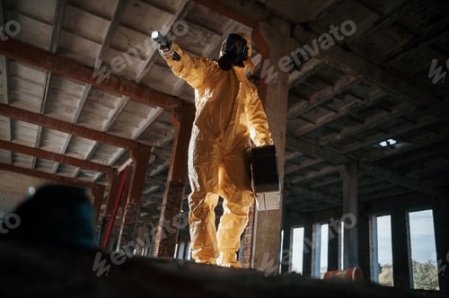 Preview: Man dressed in chemical protection suit in the ruins of the post apocalyptic building