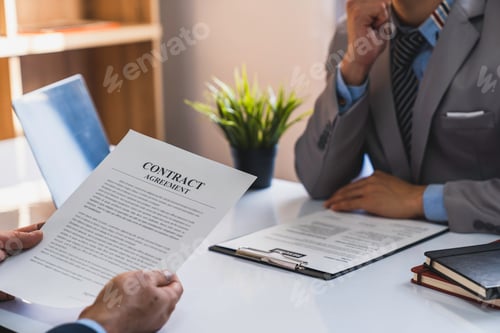 Preview: An employer interviewing for a job or head of HR is reading a resume while discussing the resume. An