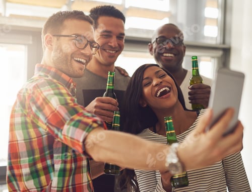 Preview: Office team taking selfie with beer bottles