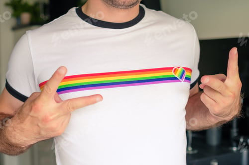 Preview: Man in the T shirt with LGBT flag shows sign Peace. Gay and lesbian rights concept