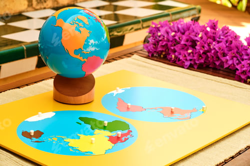 Preview: A brightly colored wooden map and globe used in a montessori school for education.