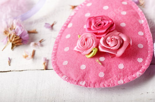 Preview: Handmade patchwork pink and lilac felt easter eggs on white wood