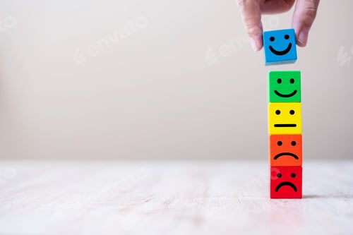 Preview: Emotion face symbol on yellow wooden cube blocks. Service rating, ranking, customer reviews