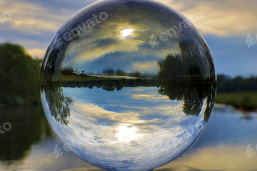 Preview: Beautiful shot of nature and lake reflection inside the glass ball
