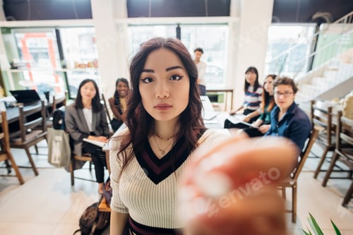 Preview: Young businesswoman preparing for presentation to colleagues