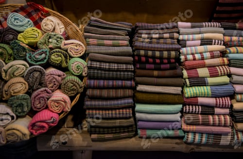 Preview: Colorful textiles neatly arranged for display.
