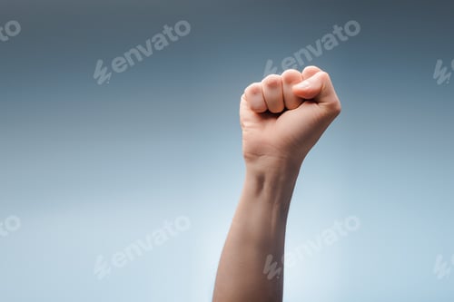 Preview: cropped view of man with clenched fist on grey, human rights concept
